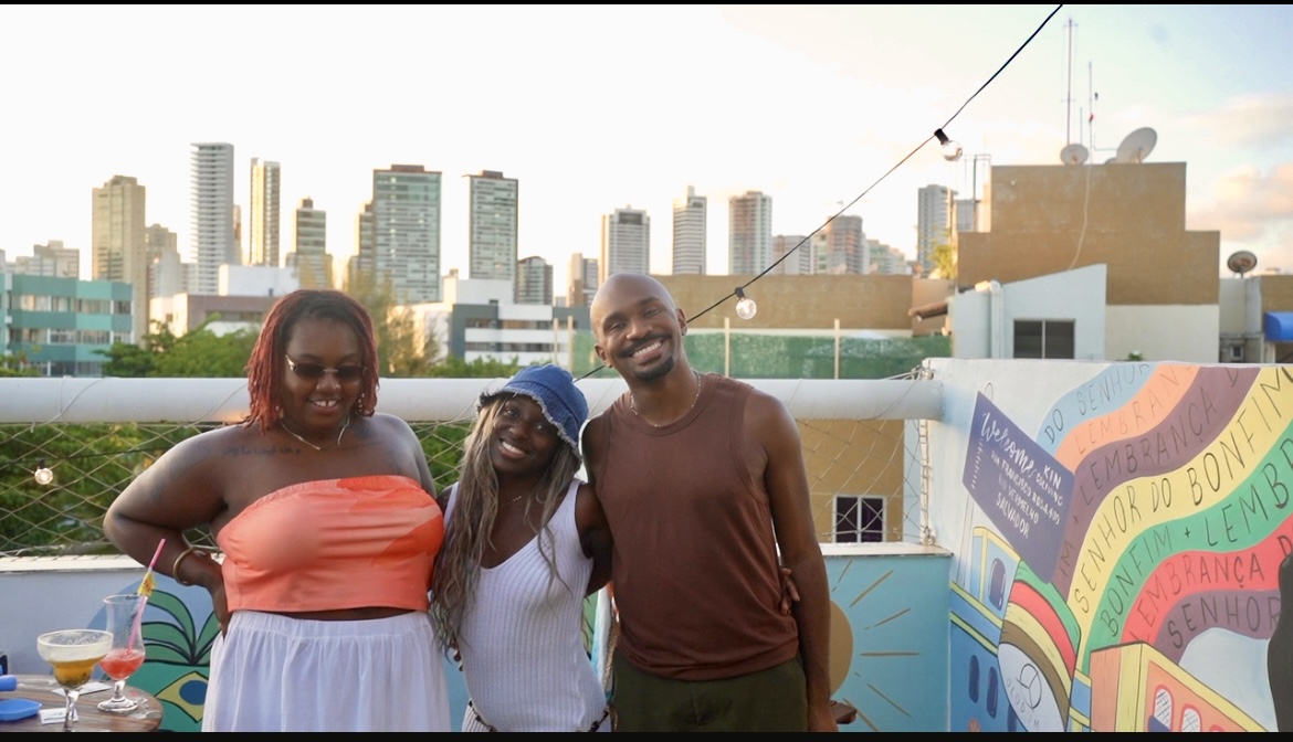 Guests together on the Kin rooftop at golden hour