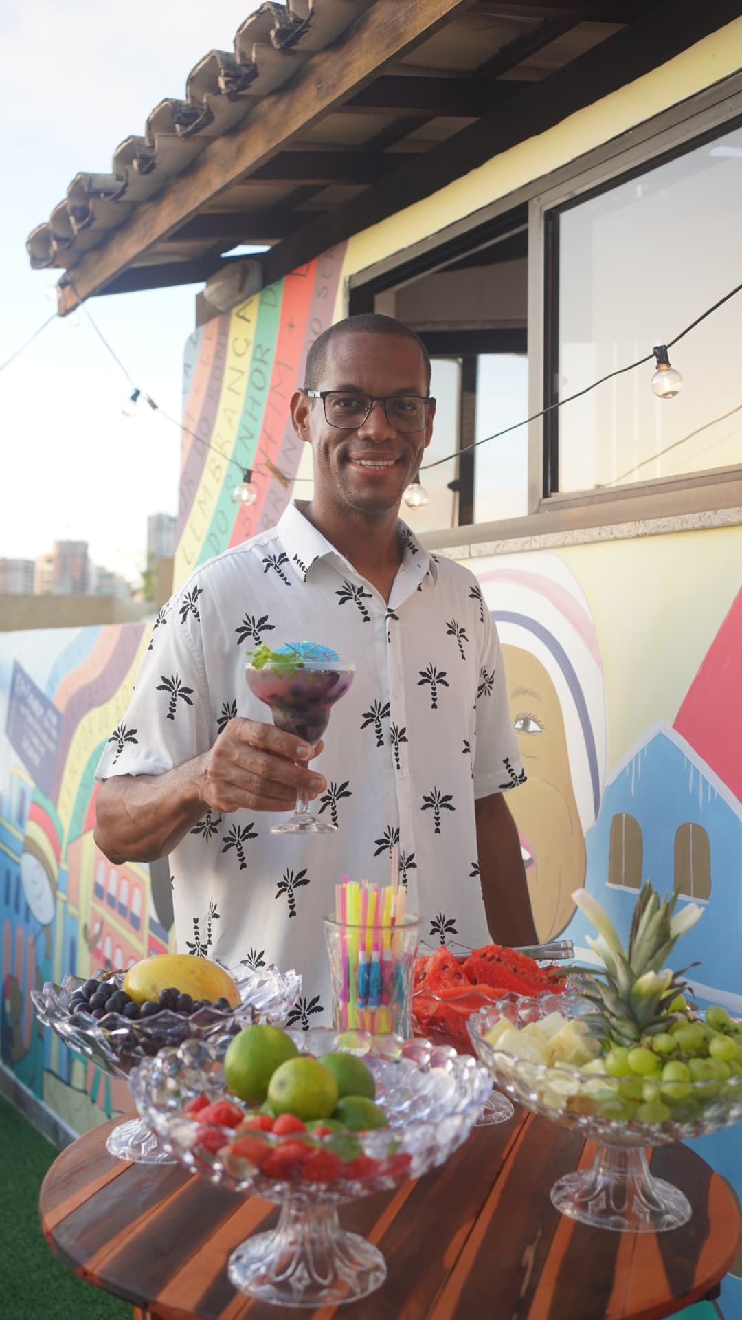 Host serving fresh cocktails at a rooftop sunset party