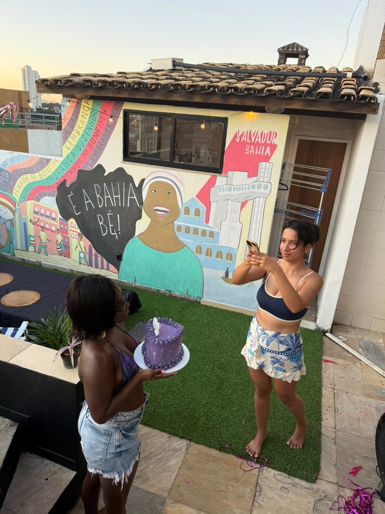 Birthday celebration in front of the Bahia mural on the rooftop